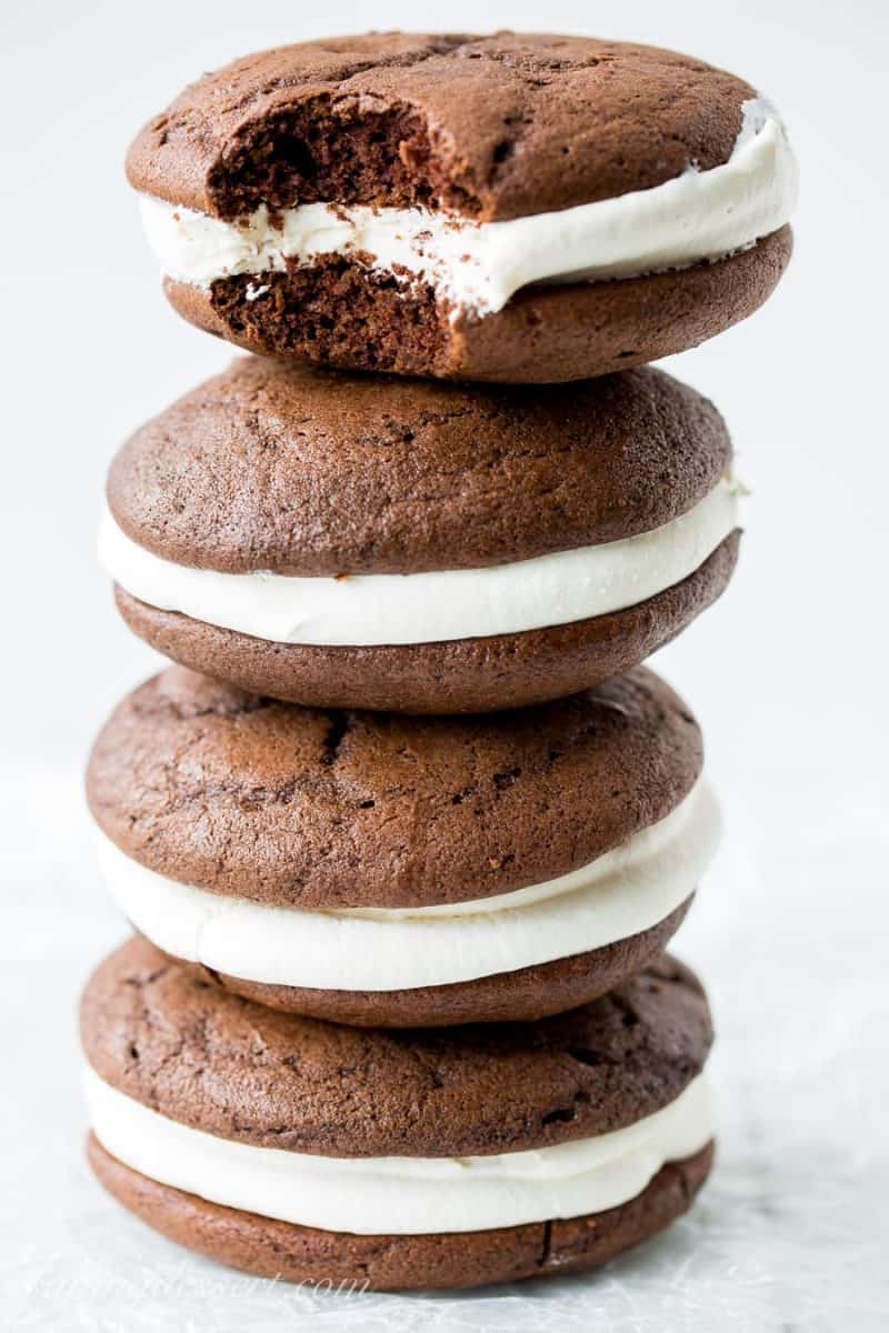 Classic Whoopie Pies ~ Chocolate cake-like batter is baked into large, soft hamburger-sized, bun shaped cookies then filled with a fluffy, sweet marshmallow frosting. www.savingdessert.com