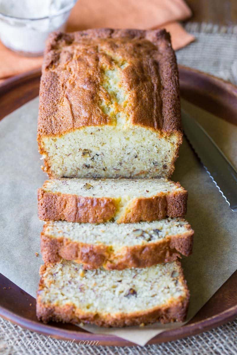 Sliced and golden brown banana bread on a tray