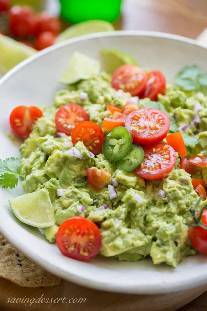 Easy Spicy Guacamole ~ incredibly delicious made fresh at your own table, hand crafted and seasoned just the way you like it ... and it's super easy to make too. www.savingdessert.com