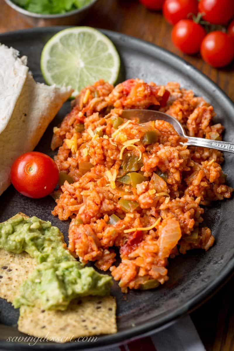Easy Spanish Rice Recipe ~ a family favorite for years, and be sure to make plenty because you'll want seconds! Sweet onion and green bell pepper compliment the tomatoes and spices in this tasty Mexican rice dish. It's a must make side dish to compliment all our favorite south-of-the-border dishes! www.savingdessert.com