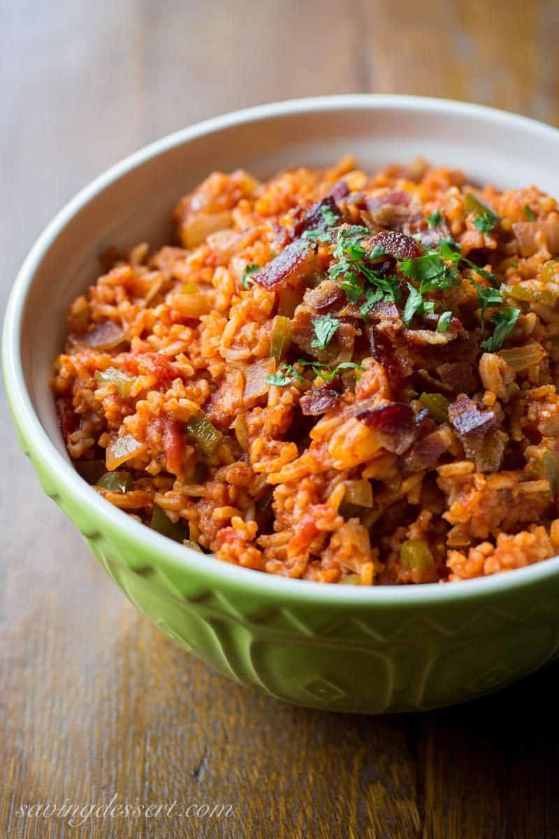 Spanish Rice in a bowl topped with crumbled bacon and parsley