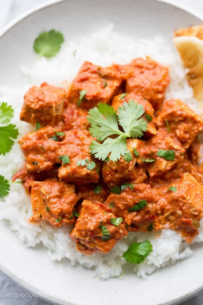 Chicken Tikka Masala ~ an incredibly popular dish made with tender chunks of yogurt marinated chicken, folded into a richly spiced tomato sauce with just a hint of heat from the cayenne. www.savingdessert.com