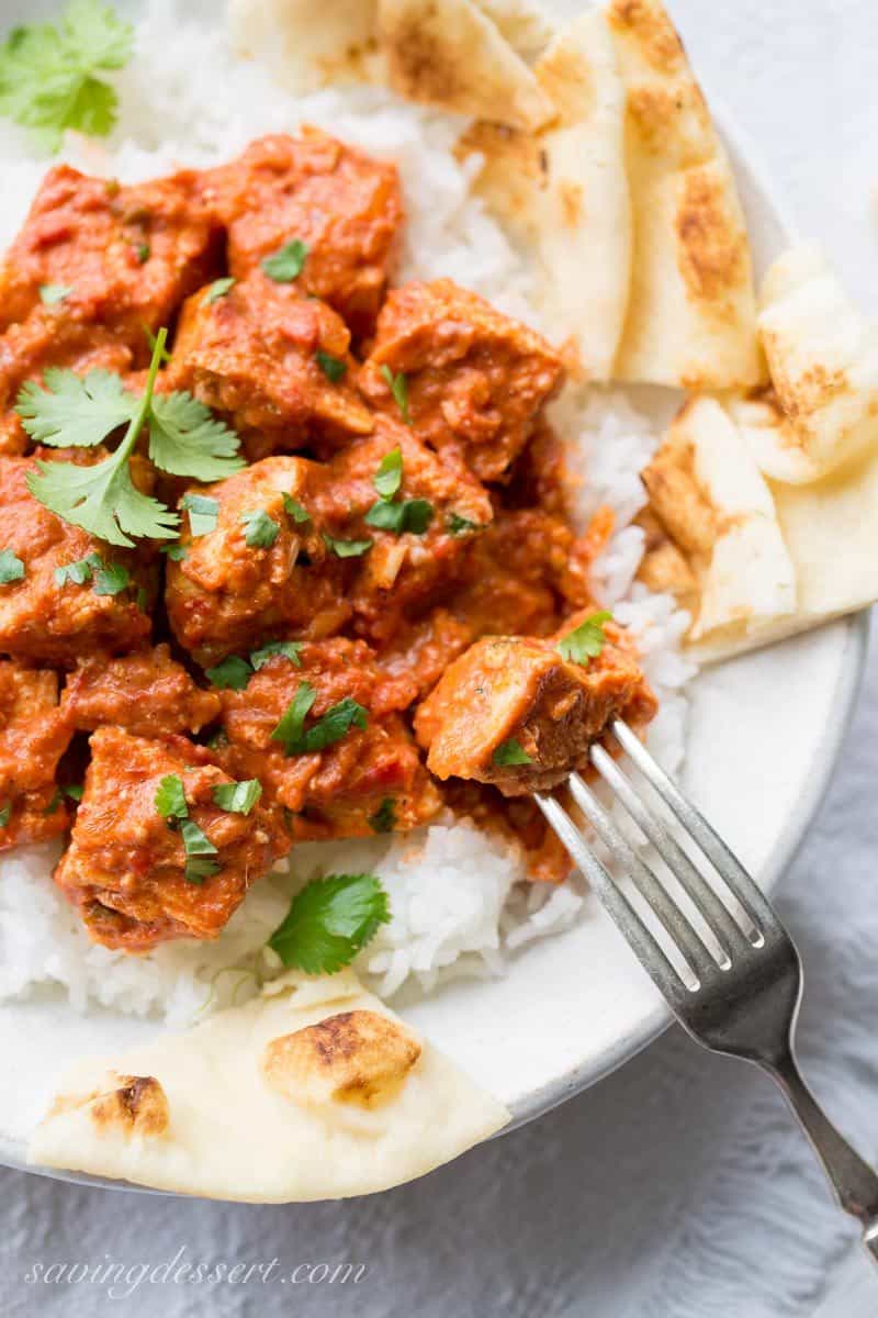 Chicken Tikka Masala ~ an incredibly popular dish made with tender chunks of yogurt marinated chicken, folded into a richly spiced tomato sauce with just a hint of heat from the cayenne. www.savingdessert.com