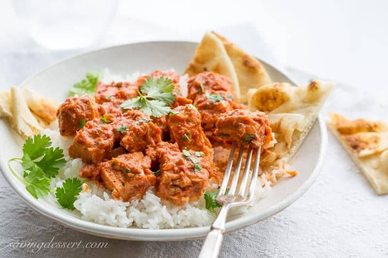 Chicken Tikka Masala ~ an incredibly popular dish made with tender chunks of yogurt marinated chicken, folded into a richly spiced tomato sauce with just a hint of heat from the cayenne. www.savingdessert.com