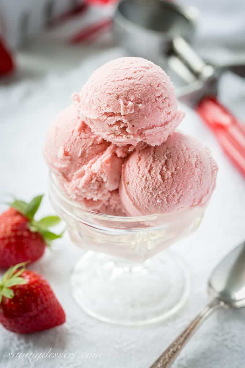 Fresh Strawberry Ice Cream ~ creamy and smooth, with tart (not sour) undertones that you'd expect from a good ripe strawberry. With a touch of Grand Marnier, buttermilk and mascarpone cheese, the richness shines through in this eggless, dreamy, frozen treat! www.savingdessert.com