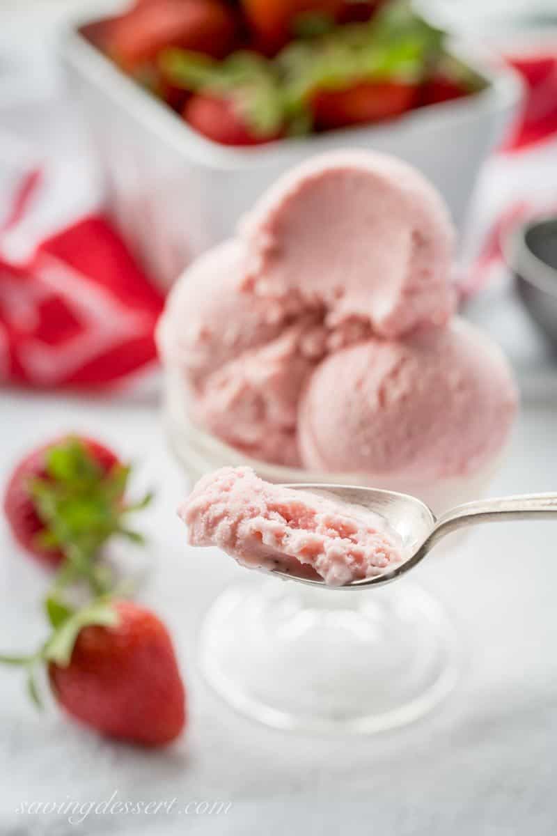 Fresh Strawberry Ice Cream ~ creamy and smooth, with tart (not sour) undertones that you'd expect from a good ripe strawberry. With a touch of Grand Marnier, buttermilk and mascarpone cheese, the richness shines through in this eggless, dreamy, frozen treat! www.savingdessert.com