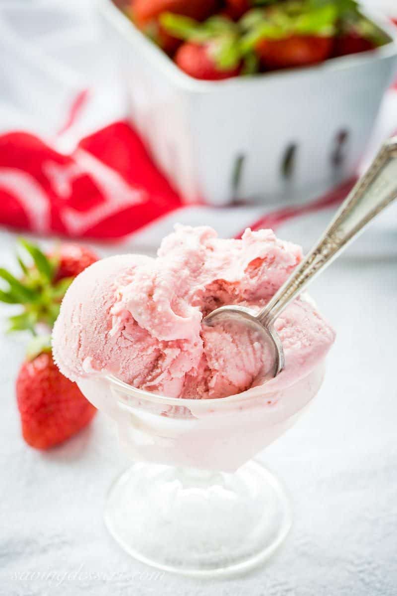 Fresh Strawberry Ice Cream ~ creamy and smooth, with tart (not sour) undertones that you'd expect from a good ripe strawberry. With a touch of Grand Marnier, buttermilk and mascarpone cheese, the richness shines through in this eggless, dreamy, frozen treat! www.savingdessert.com