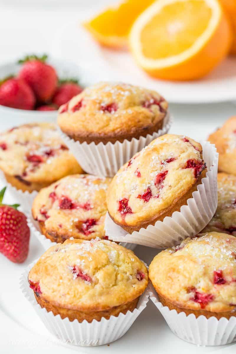 A plate of strawberry muffins topped with coarse sugar