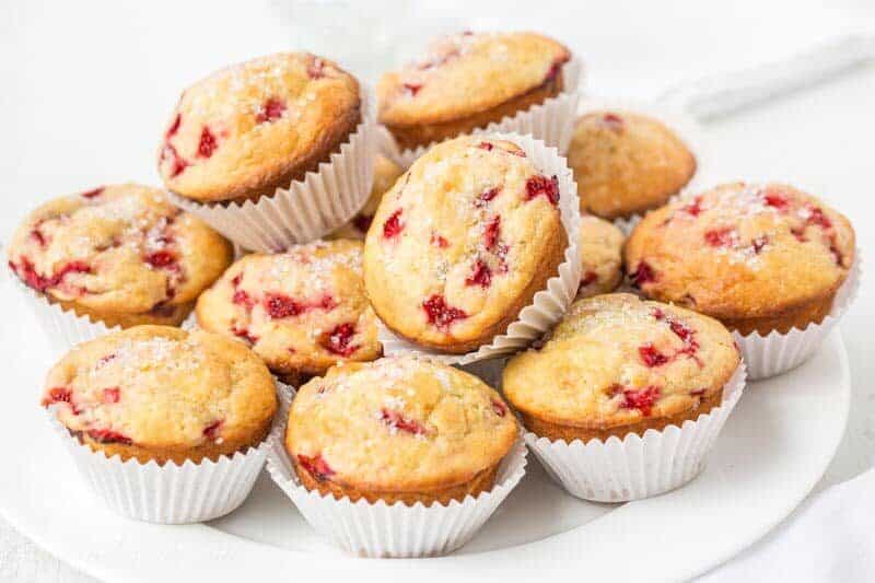 A plate of orange scented strawberry muffins topped with sugar