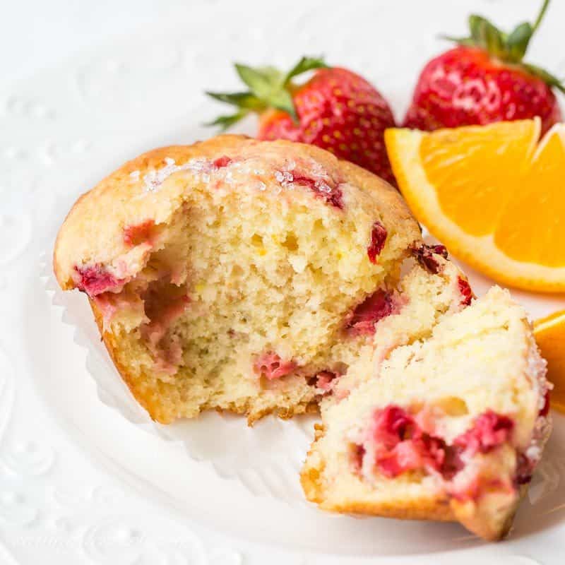 A strawberry muffin broken open to show a moist tender texture