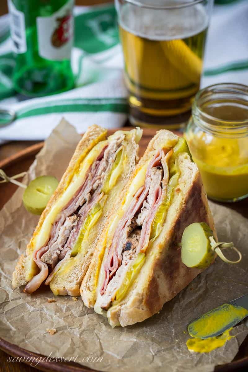 A cuban sandwich with pickles, sliced in half