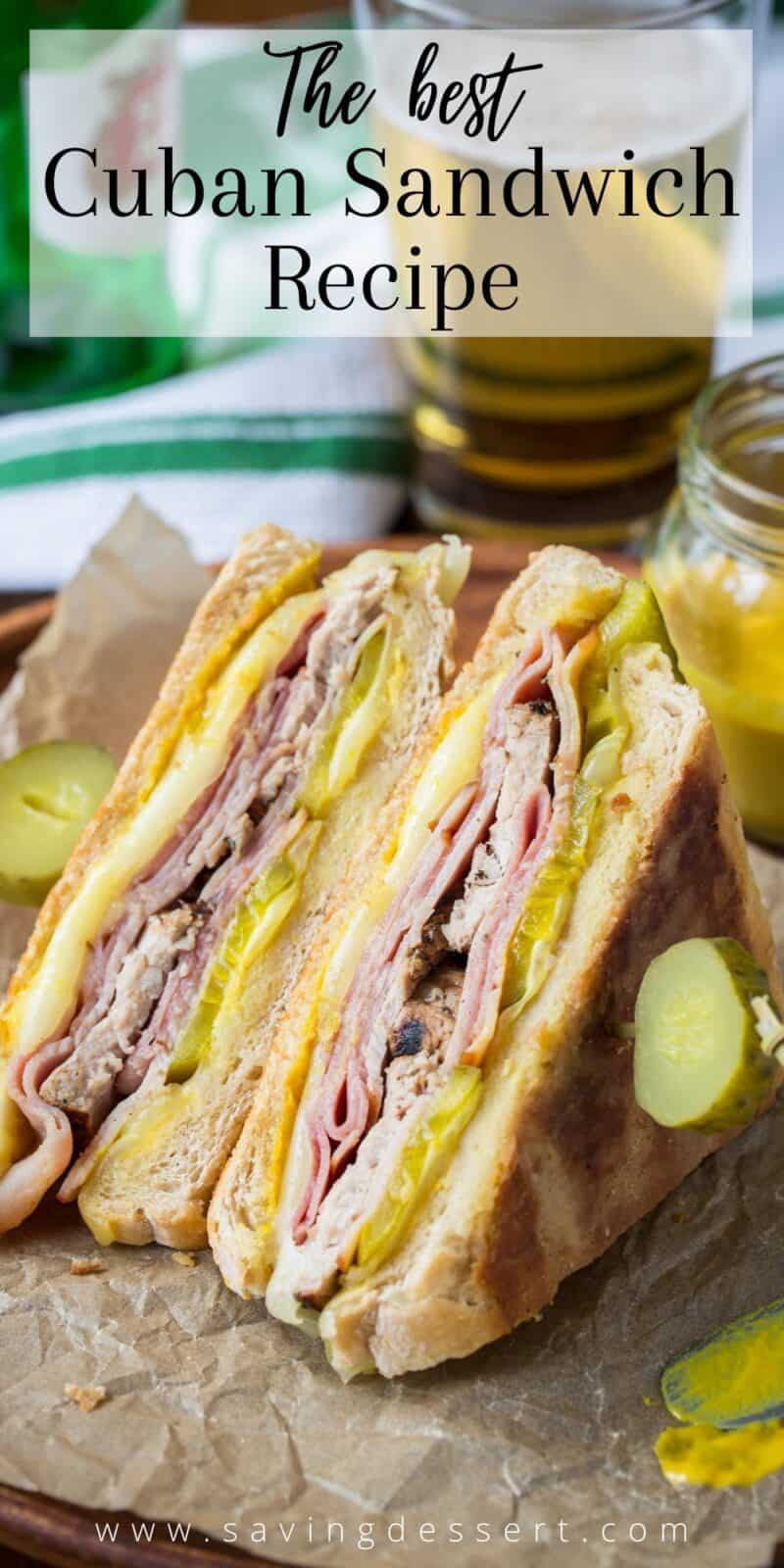 A grilled Cuban sandwich cut in half on a tray served with pickles