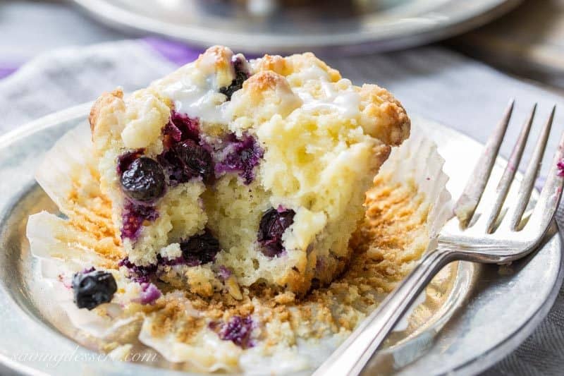 Lemon Blueberry Muffins with a Lemon Crumble Topping ~ Plump, ripe blueberries and tart lemon juice are the stars in these wonderfully moist, sour cream muffins. Not overly sweet, these muffins are terrific with or without the bright lemon glaze. www.savingdessert.com