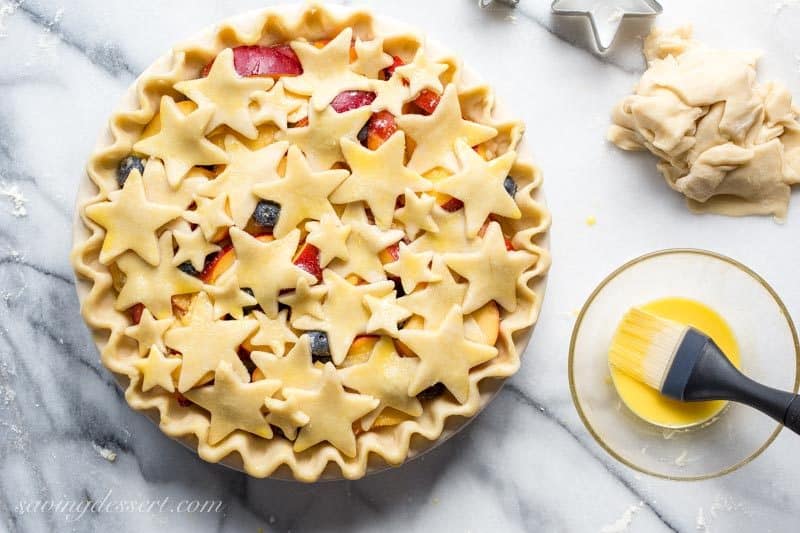 Nectarine Blueberry Pie ~ bake the season with this juicy, tangy, sweet pie filled with ripe nectarines and plump blueberries. Topped with a homemade flaky crust cut into shapes with your favorite cookie cutter, you'll be the star of your next celebration with this delicious dessert! www.savingdessert.com