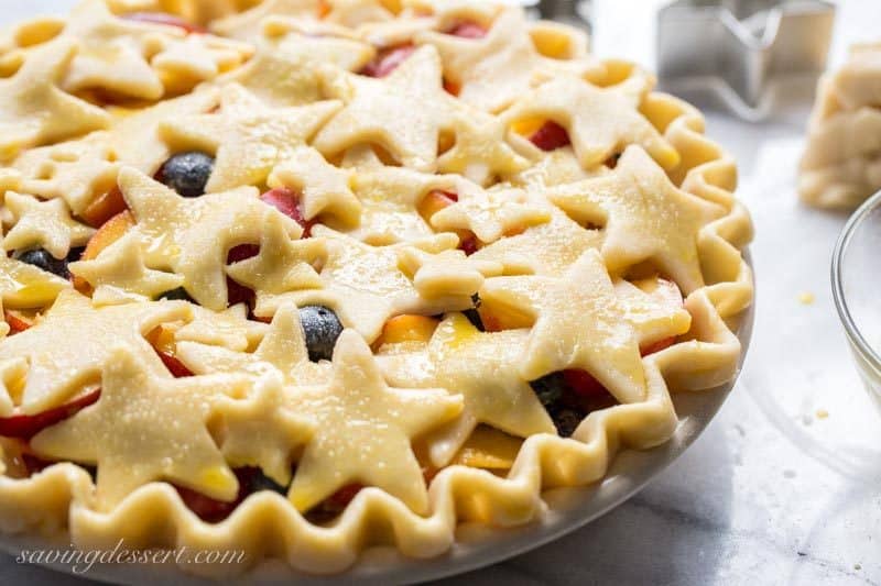 Nectarine Blueberry Pie ~ bake the season with this juicy, tangy, sweet pie filled with ripe nectarines and plump blueberries. Topped with a homemade flaky crust cut into shapes with your favorite cookie cutter, you'll be the star of your next celebration with this delicious dessert! www.savingdessert.com