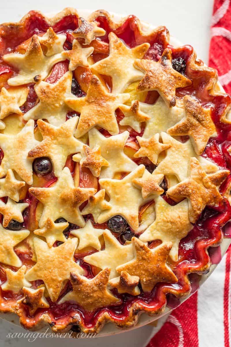 Nectarine Blueberry Pie ~ bake the season with this juicy, tangy, sweet pie filled with ripe nectarines and plump blueberries. Topped with a homemade flaky crust cut into shapes with your favorite cookie cutter, you'll be the star of your next celebration with this delicious dessert! www.savingdessert.com