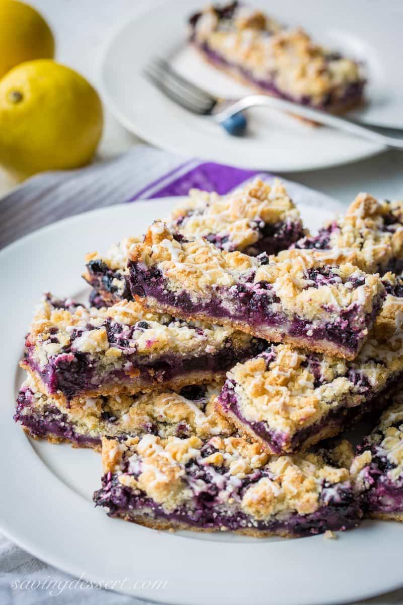 A side view of a plate of blueberry bars drizzled with icing