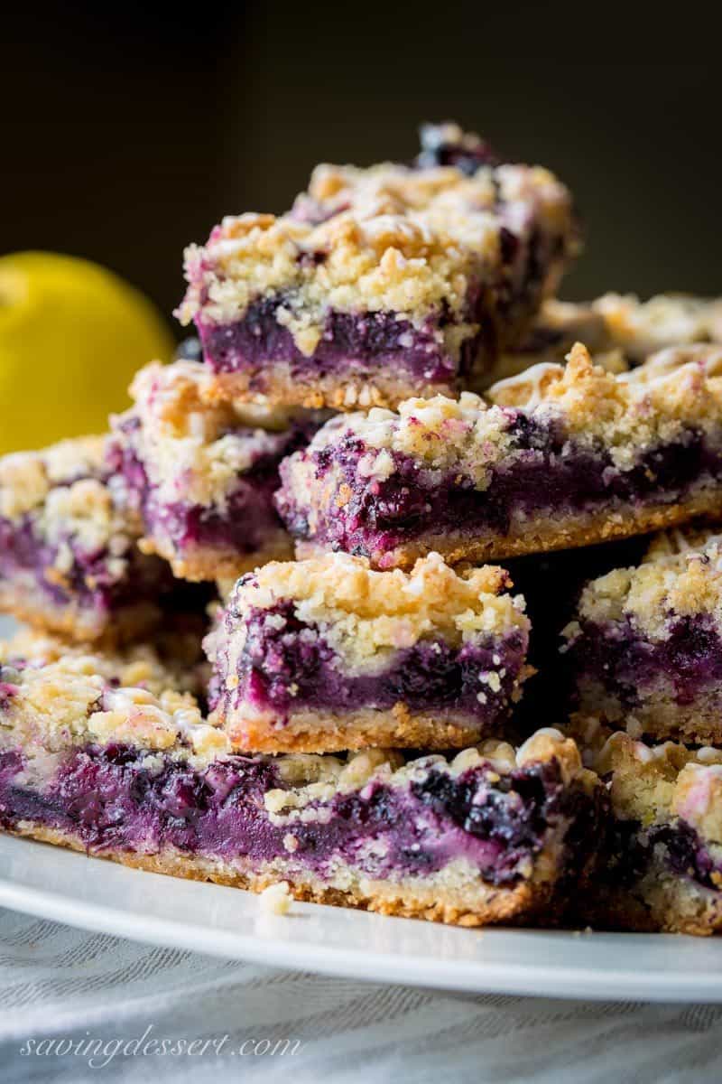 Blueberry crumb bars stacked on a plate