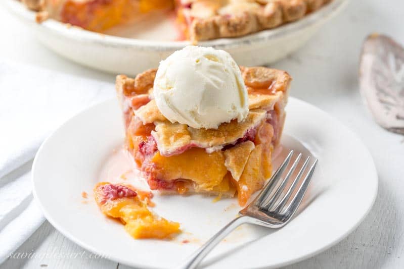 Peach Raspberry Pie with a Lattice Crust ~ juicy, sweet summer peaches are combined with tart raspberries for a wonderful seasonal dessert.  Topped with a flaky, pretty, lattice weaved crust, this pie is a family favorite! www.savingdessert.com