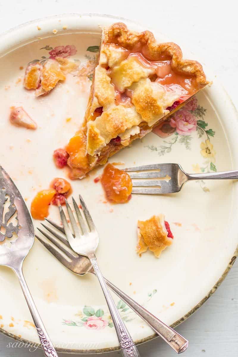 Peach Raspberry Pie with a Lattice Crust ~ juicy, sweet summer peaches are combined with tart raspberries for a wonderful seasonal dessert.  Topped with a flaky, pretty, lattice weaved crust, this pie is a family favorite! www.savingdessert.com