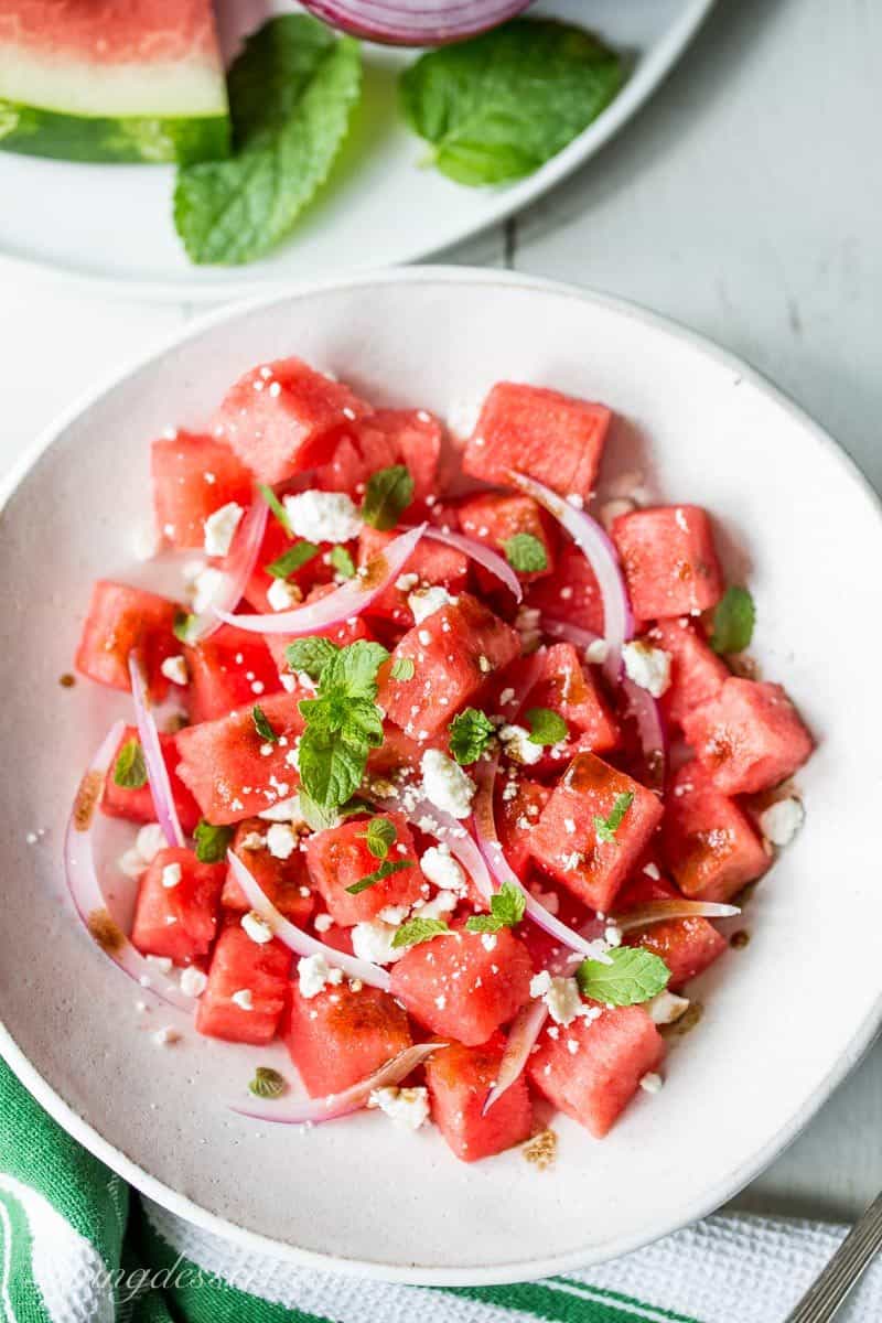 Watermelon salad with onions, feta cheese and mint in a bowl