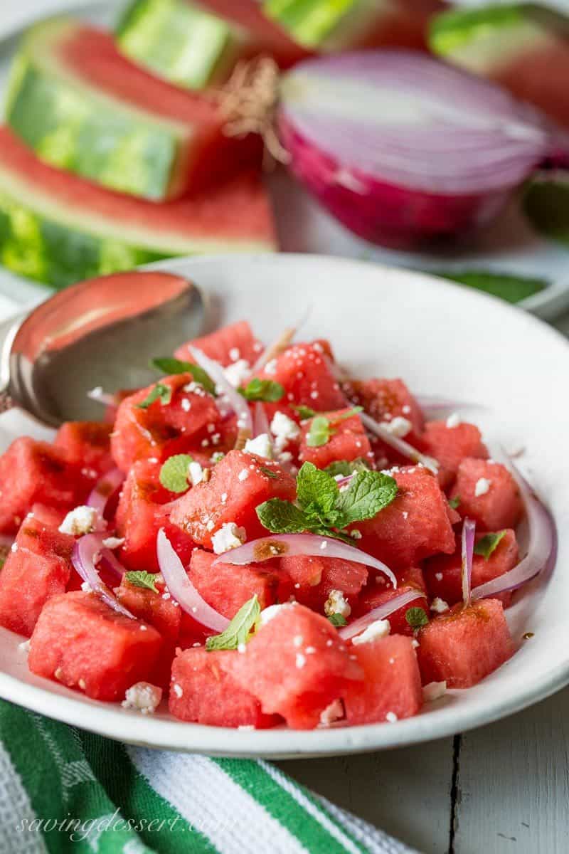 Watermelon Salad with Balsamic Vinaigrette ~ you won't believe how perfectly sweet summer watermelon combines with fresh mint, crisp red onions and creamy Feta cheese.  With just a drizzle of balsamic vinaigrette, you'll be amazed at the delicious flavor that comes from just a few simple ingredients. www.savingdessert.com