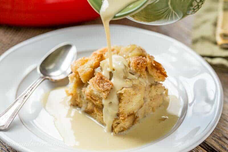 A slice of apple bread pudding drizzled with apple brandy sauce