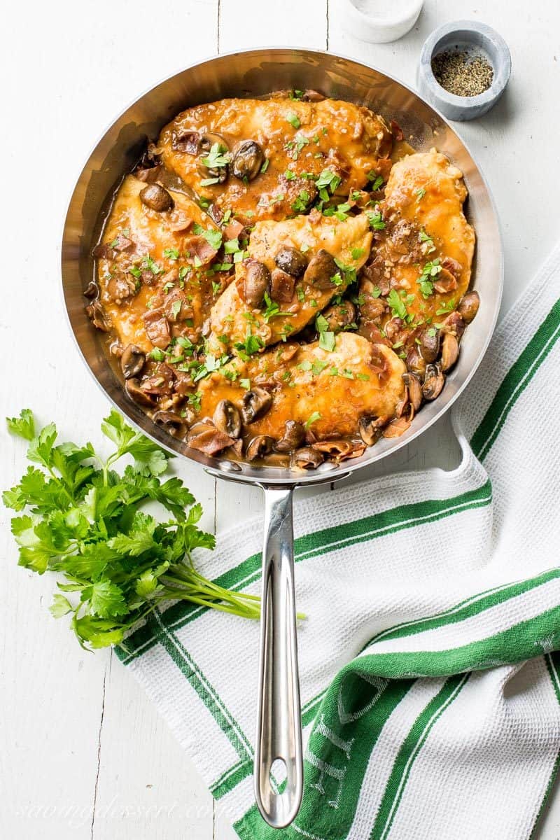 Classic Chicken Marsala ~ tender chicken breasts are seasoned and sautéed, then simmered in a Marsala wine sauce with shallots, prosciutto, and plenty of earthy mushrooms.  Your guests never have to know how easy this is to make! savingdessert.com #chickenmarsala #chickendish #chicken #chickenmushrooms #marsala