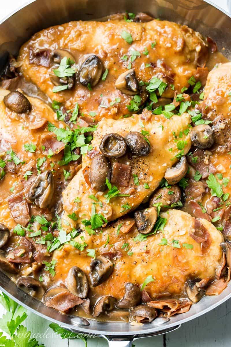 Classic Chicken Marsala ~ tender chicken breasts are seasoned and sautéed, then simmered in a Marsala wine sauce with shallots, prosciutto, and plenty of earthy mushrooms. Your guests never have to know how easy this is to make! savingdessert.com #chickenmarsala #chickendish #chicken #chickenmushrooms #marsala