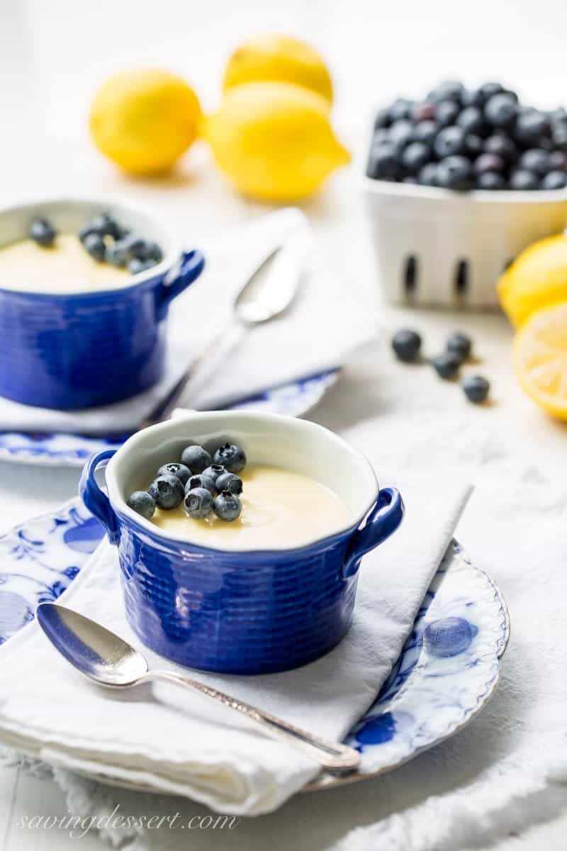Bowls of lemon posset with blueberries on top