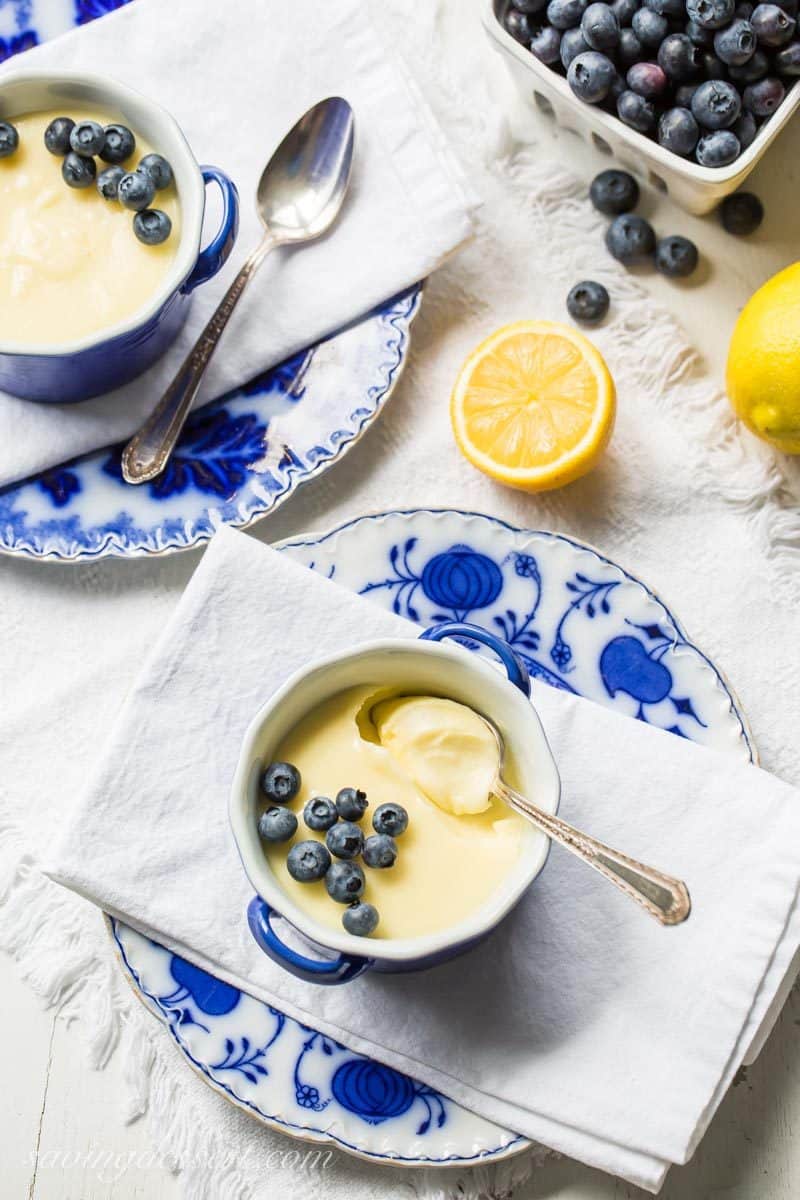 Lemon posset in cups topped with blueberries