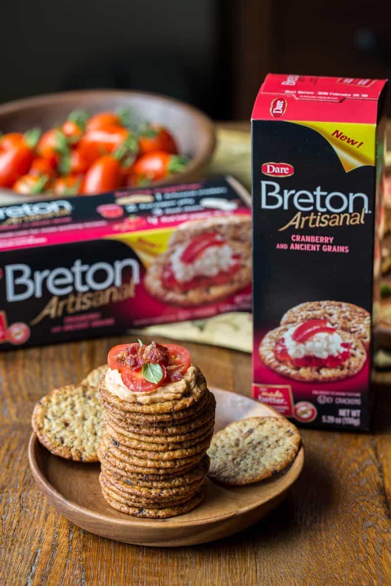 Mini BBQ BLT Appetizers - cream cheese blended with BBQ sauce then spread on our favorite Breton Artisanal Cranberry and Ancient Grains crackers.  Topped with sliced cherry tomatoes and crumbled bacon, entertaining couldn't be easier! www.savingdessert.com