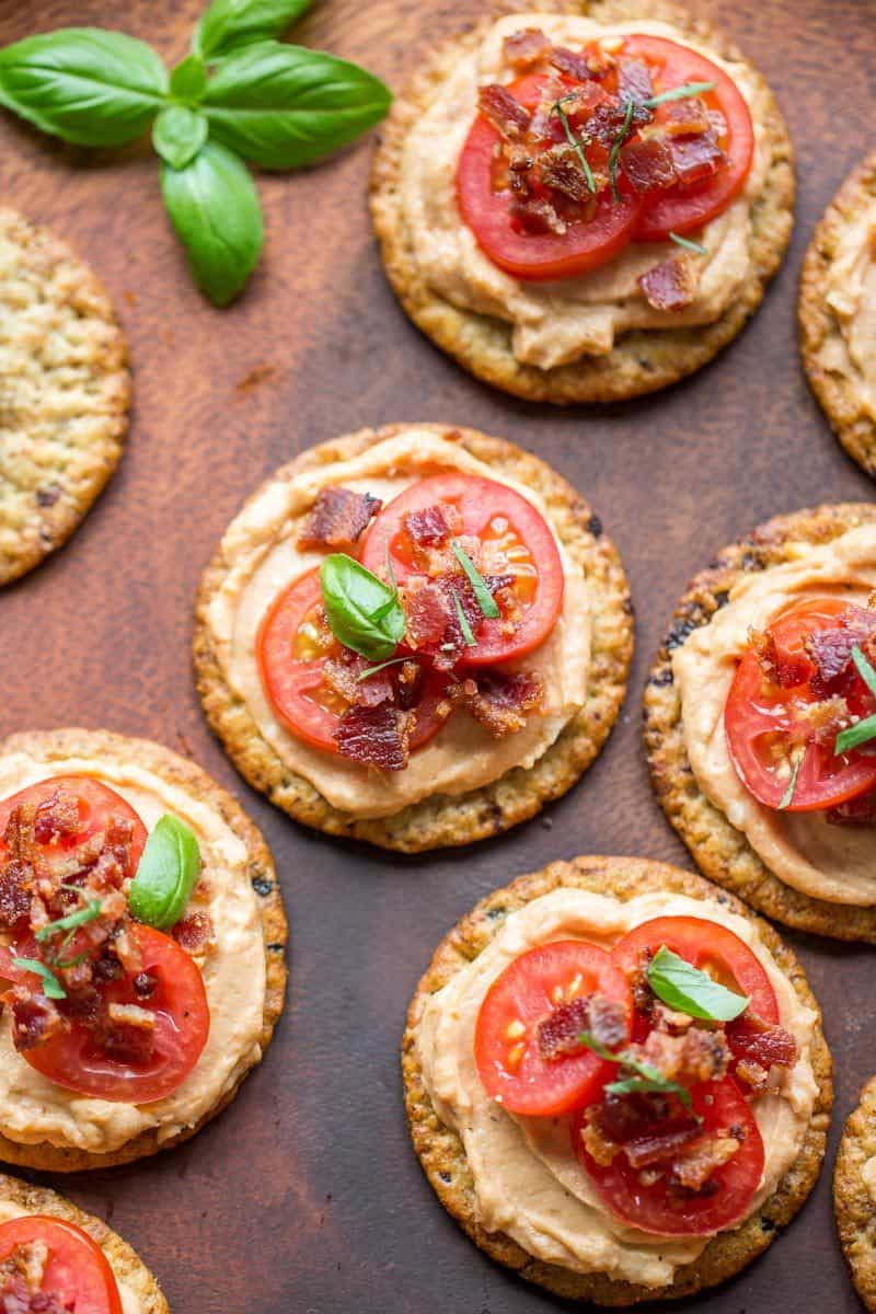 Mini BBQ BLT Appetizers - cream cheese blended with BBQ sauce then spread on our favorite Breton Artisanal Cranberry and Ancient Grains crackers.  Topped with sliced cherry tomatoes and crumbled bacon, entertaining couldn't be easier! www.savingdessert.com