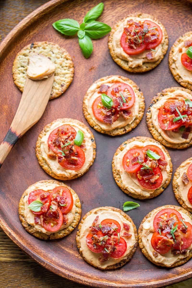 Mini BBQ BLT Appetizers - cream cheese blended with BBQ sauce then spread on our favorite Breton Artisanal Cranberry and Ancient Grains crackers.  Topped with sliced cherry tomatoes and crumbled bacon, entertaining couldn't be easier! www.savingdessert.com