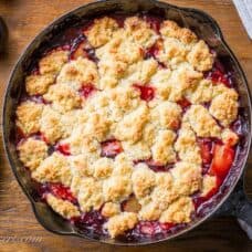 A skillet filled with plum cobbler