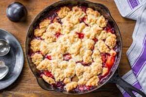 A skillet filled with plum cobbler