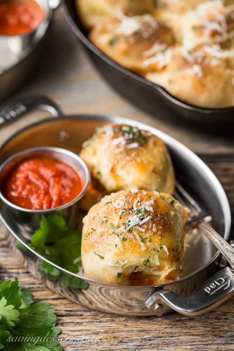Mini Skillet Meatball Calzones served with pizza sauce for dipping