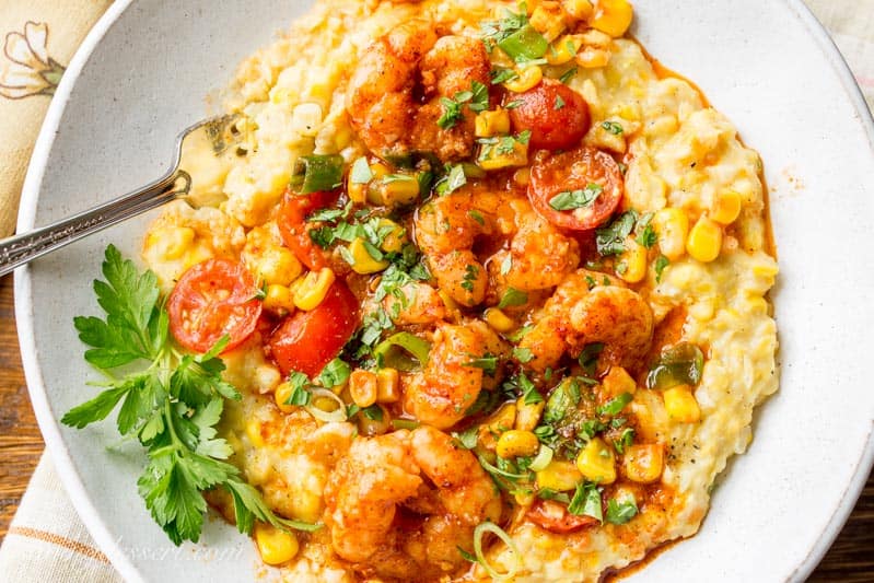 A bowl of spicy shrimp over creamed corn