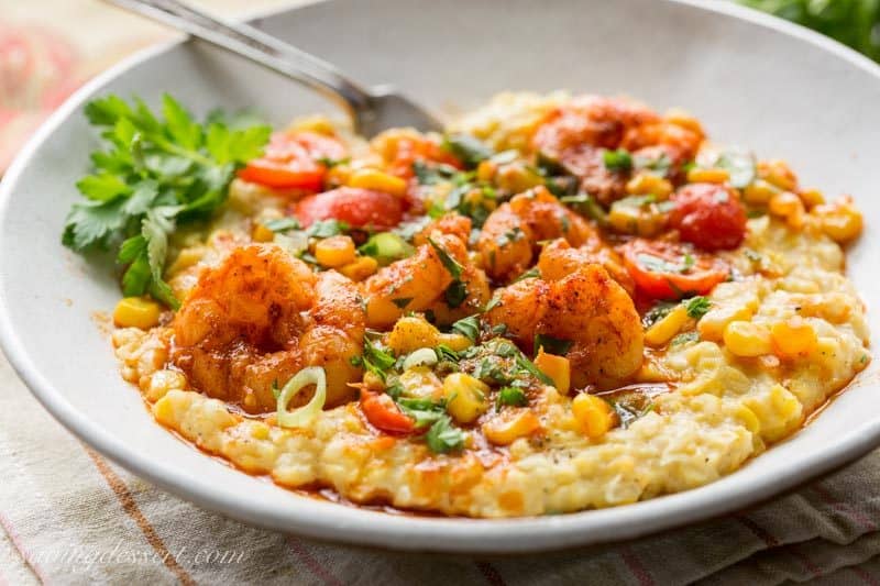 Spicy Shrimp &amp;amp; Fried Corn ~ A fresh and tasty twist on classic shrimp and grits! Creamy, sweet fried corn is topped with spicy shrimp, garden fresh tomatoes and green onions for a delicious bowl of healthy comfort food! www.savingdessert.com