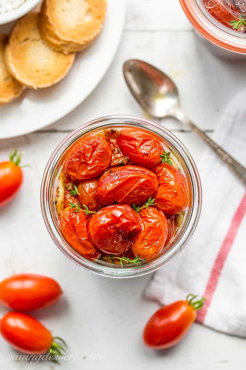 Sweet summer tomatoes are slow cooked in the oven with olive oil, garlic, crushed red pepper and a handful of fresh thyme.  www.savingdessert.com