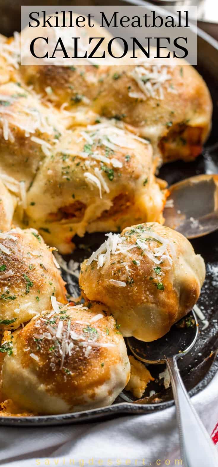 A cast iron skillet filled with mini meatball calzones