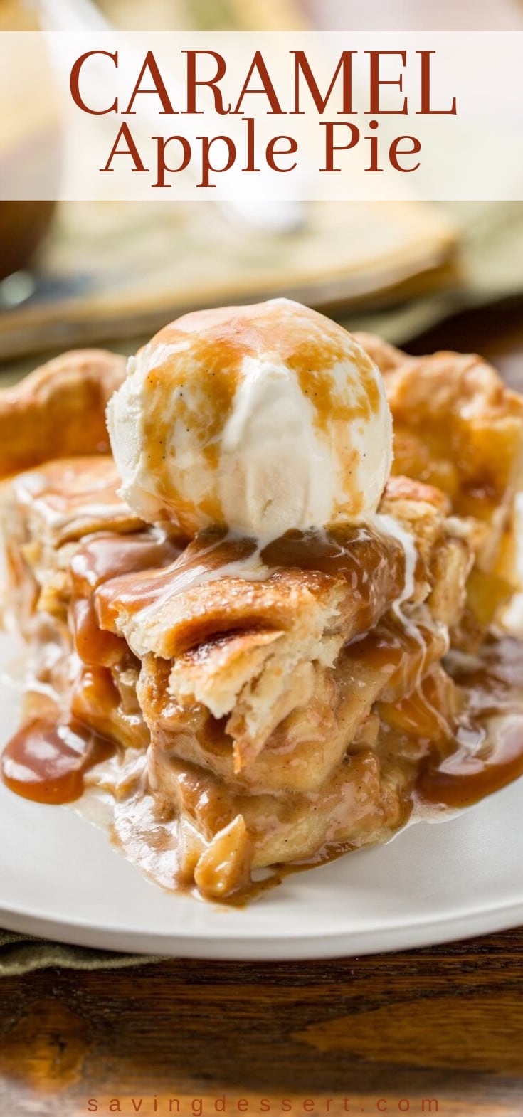 A slice of caramel apple pie topped with a scoop of ice cream and more caramel
