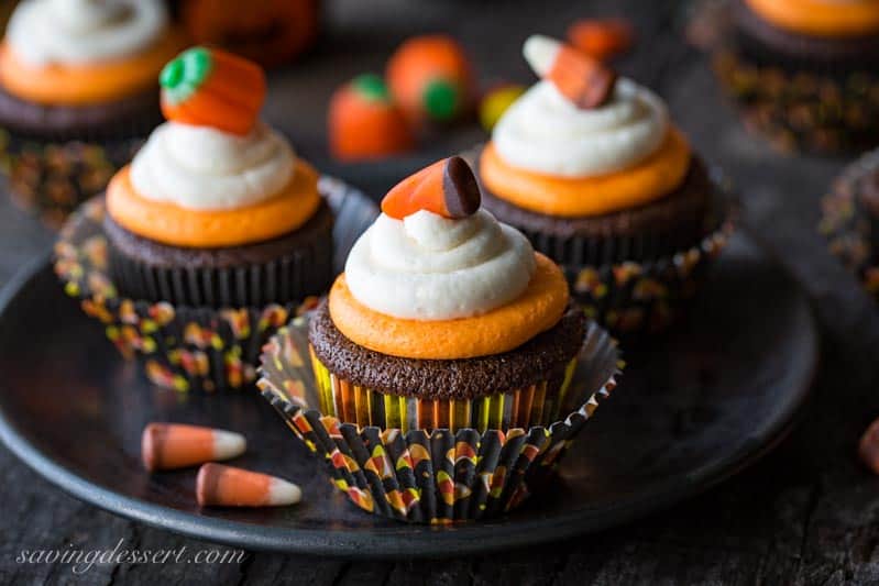 Easy Chocolate Cupcakes Recipe with Fluffy Vanilla Buttercream Frosting ~  classic chocolate cupcakes that are tender and moist, and don't fall apart when you take a big bite. Topped with fluffy, melt in your mouth buttercream frosting with just a little bit of cream cheese added for stability and creaminess.  Not just for Halloween! savingdessert.com #savingroomfordessert #cupcakes #halloween #chocolatecupcakes #chocolatecake #cake #mayonnaisecake #dessert #candycorn