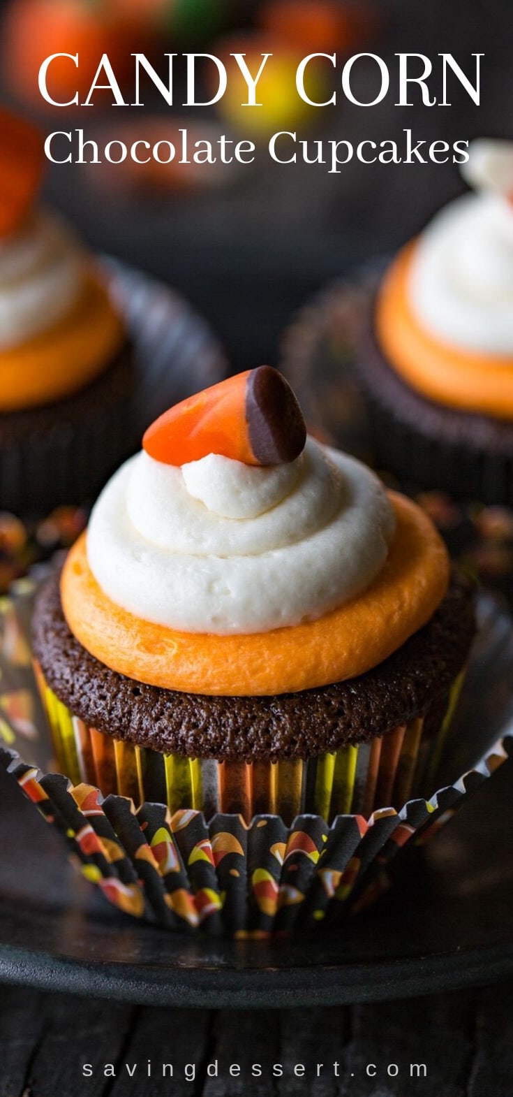 A chocolate cupcake topped with buttercream icing and a candy corn on top