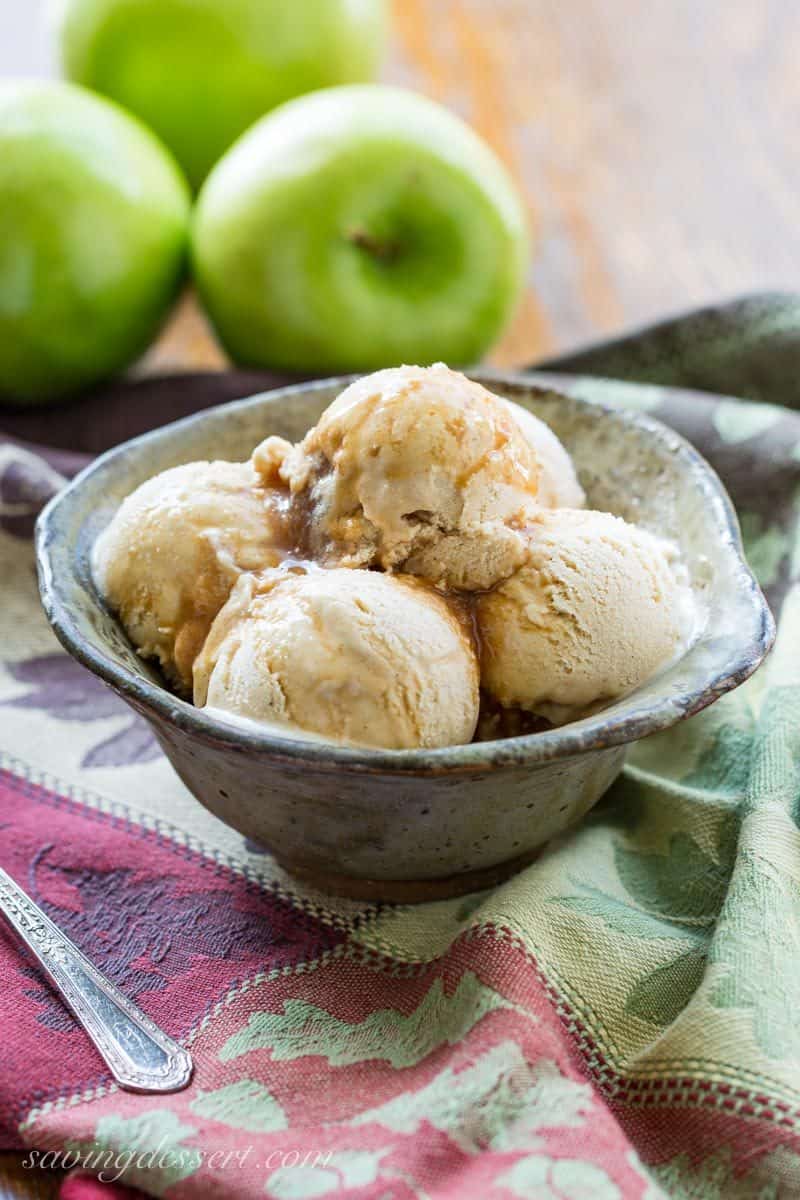 A bowl of apple cider ice cream with apple cider syrup drizzled throughout