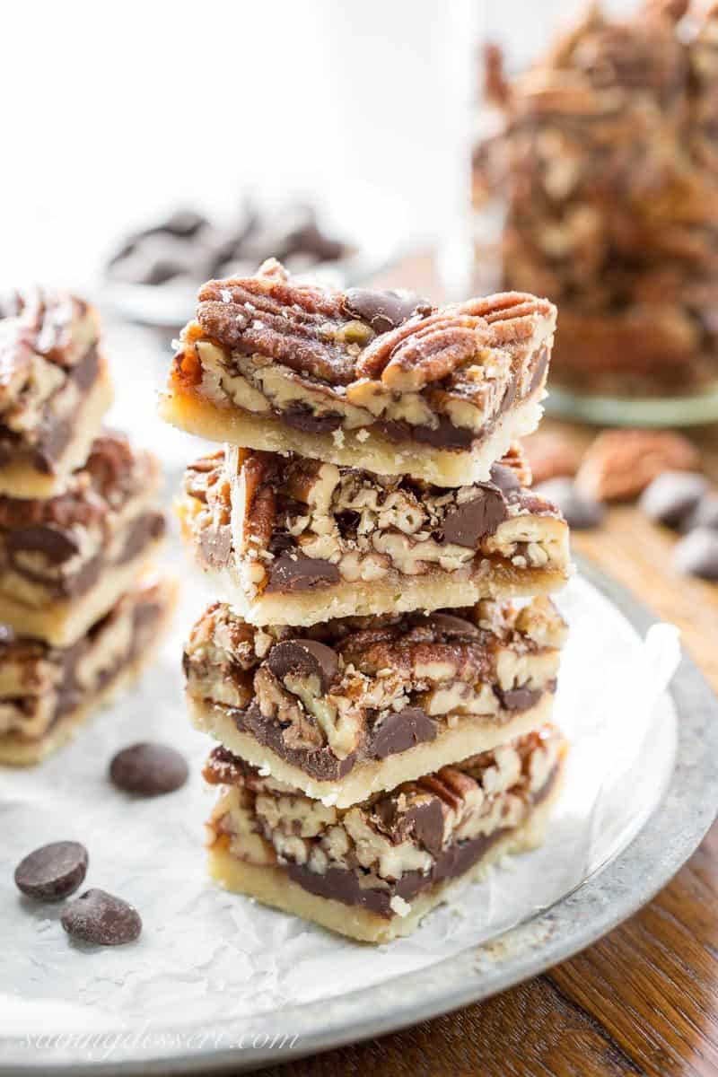 Chocolate Pecan Pie Bars with Bourbon & Sea Salt ~ a delicious and super nutty take on one of our favorite holiday pies! More toasty nuts and less filling than the pecan pies we all love, these bars are much easier to make too. www.savingdessert.com #savingroomfordessert #pecanpie #pecanpiebars #pecanbars #chocolatepecan #dessert #holidaybaking #piebars