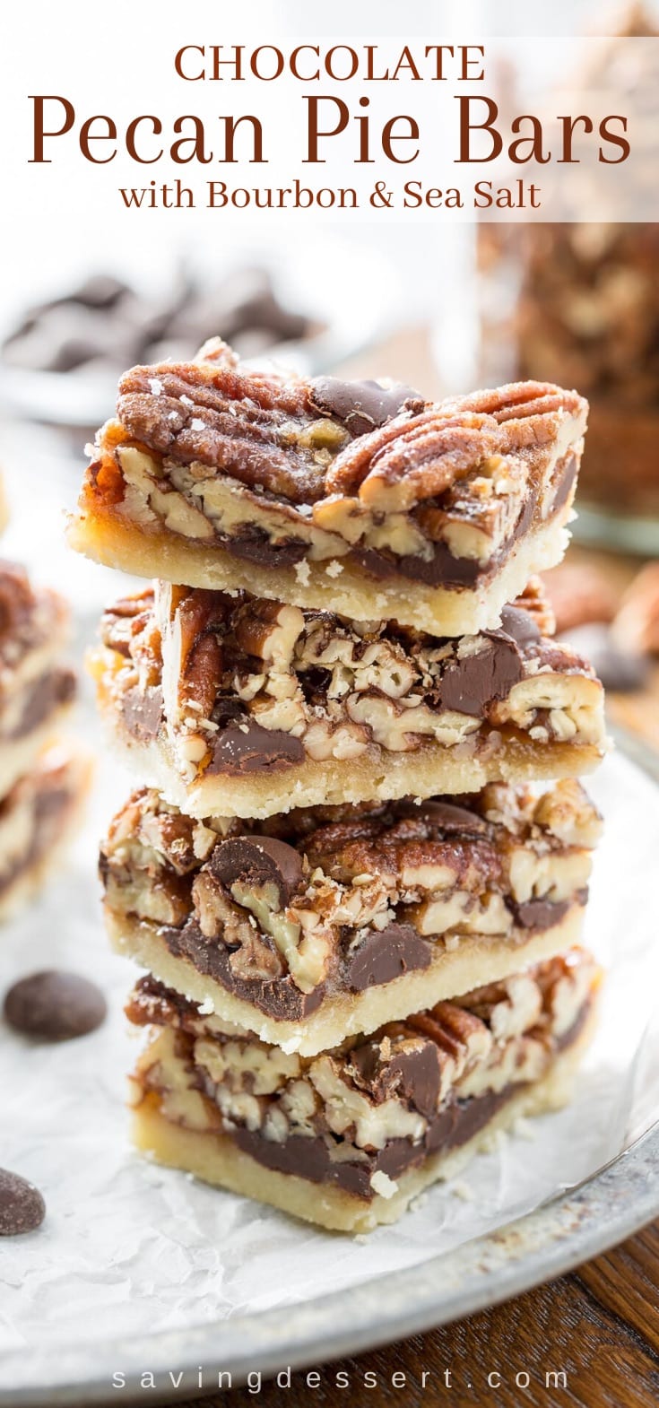 A stack of chocolate pecan pie bars loaded with pecans and chocolate chips