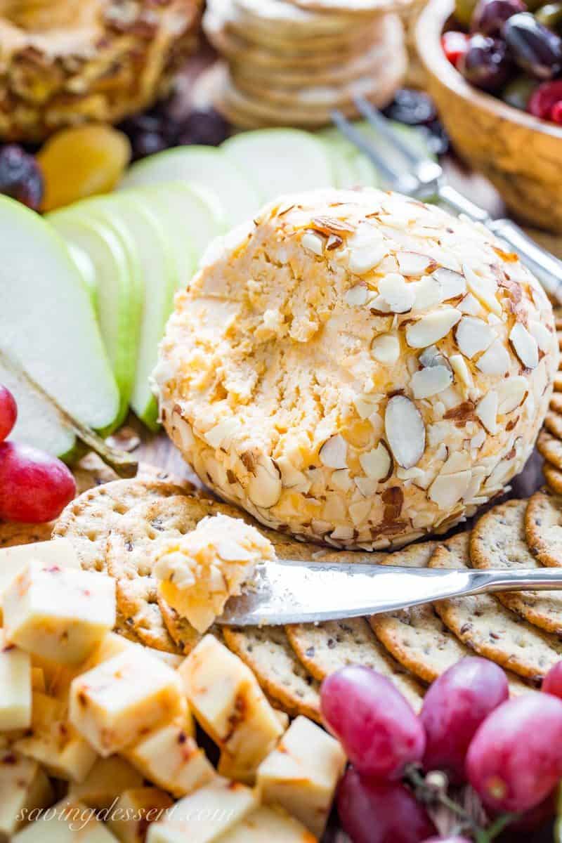 Mom's Party Cheeseball ~ every party needs an easy and delicious cheese ball made with cream cheese, mild and sharp cheddar cheese and a few spices. A make ahead appetizer that holds up wonderfully for hours and is great served with crackers, bread, fruit and nuts. www.savingdessert.com #cheeseball #appetizer #savingroomfordessert #partyappetizer