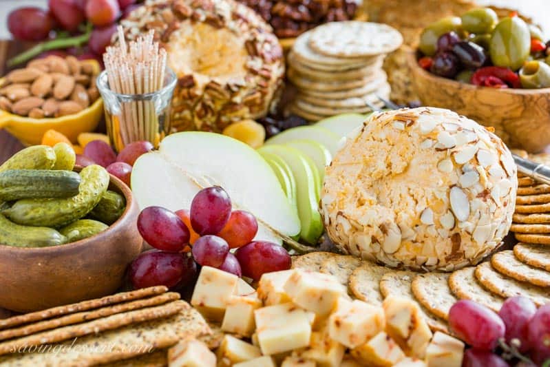 Mom's Party Cheeseball ~ every party needs an easy and delicious cheese ball made with cream cheese, mild and sharp cheddar cheese and a few spices. A make ahead appetizer that holds up wonderfully for hours and is great served with crackers, bread, fruit and nuts. www.savingdessert.com #cheeseball #appetizer #savingroomfordessert #partyappetizer