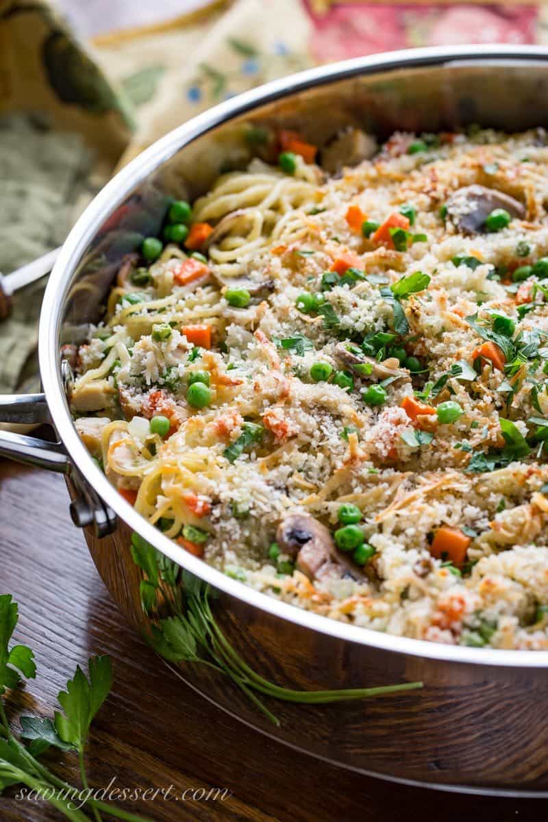 Turkey Tetrazzini Recipe - put your leftover turkey to work in this creamy, hearty casserole loaded with peas, carrots, Parmesan cheese and plenty of mushrooms. www.savingdessert.com #savingroomfordessert #turkey #tetrazzini #turkeycasserole #leftoverturkey #thanksgiving #turkeytetrazzini